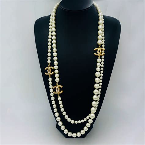 chanel black and crystal statement necklace|Chanel pearl long strand necklaces.